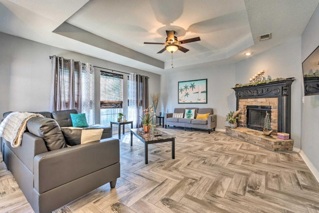 a living room with a couch and a fireplace at Private Gulf Breeze Gem with Easy Shore Access! in Navarre