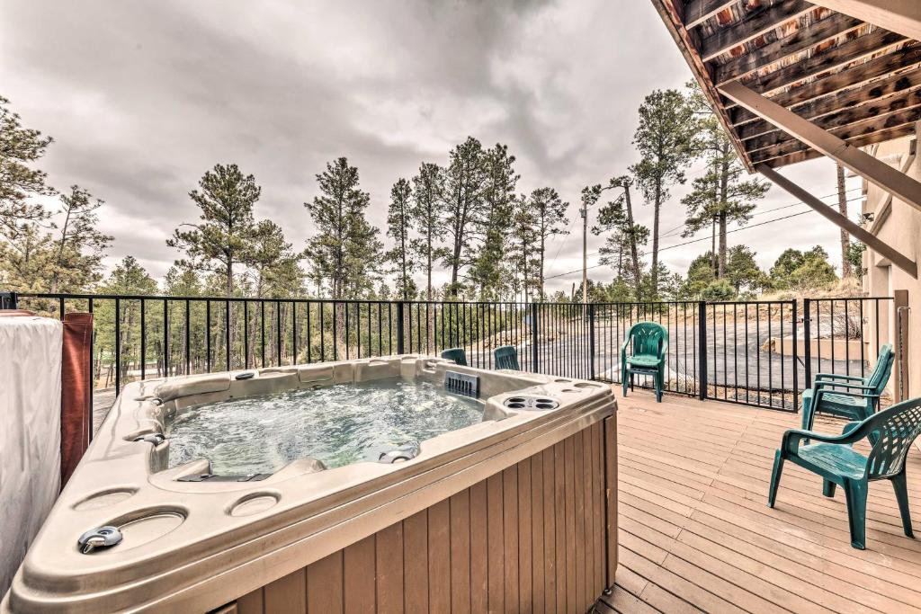 a hot tub on a deck with two chairs at Hot Tub & Mtn Views! 'Casa Ruidoso' Cabin in Alto