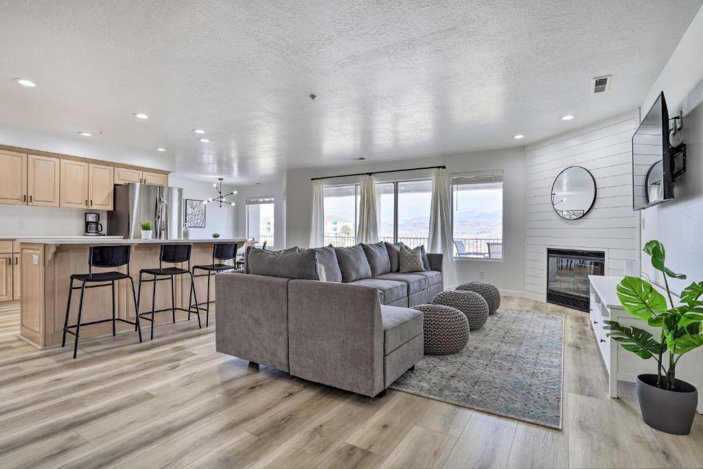 a living room with a couch and a kitchen at Luxe Family Condo with Mtn View and Resort Perks! in St. George