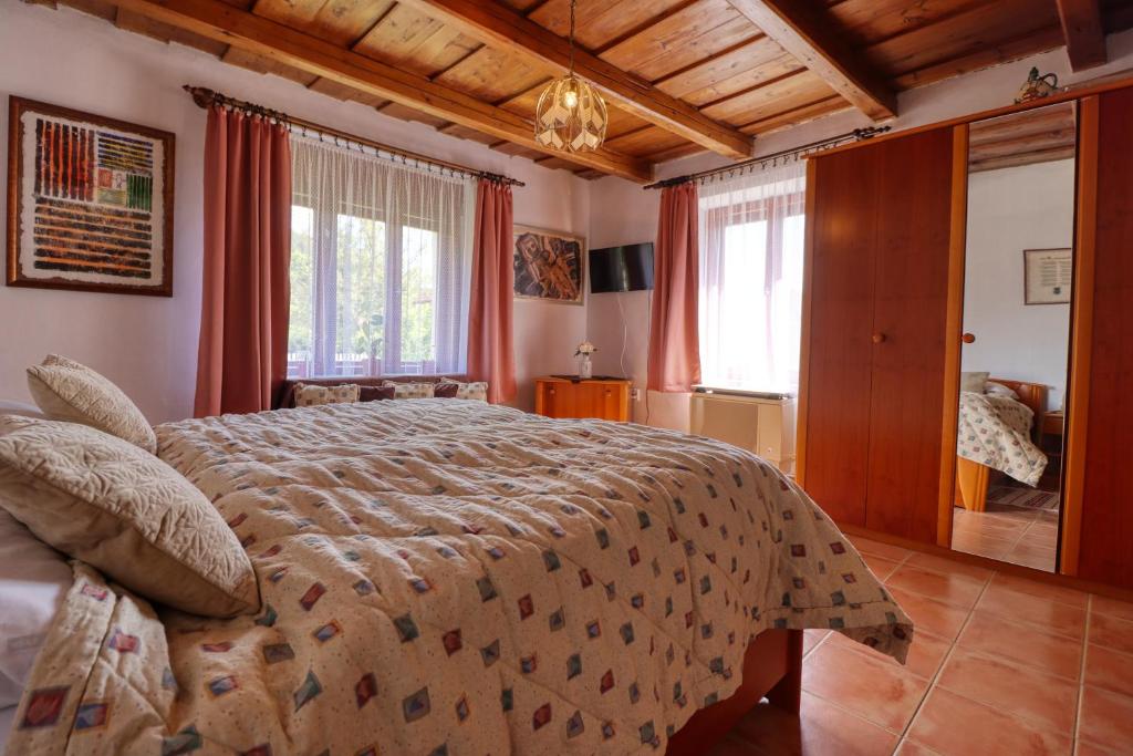 a bedroom with a large bed in a room at Napfény Vendégház in Bükkszék