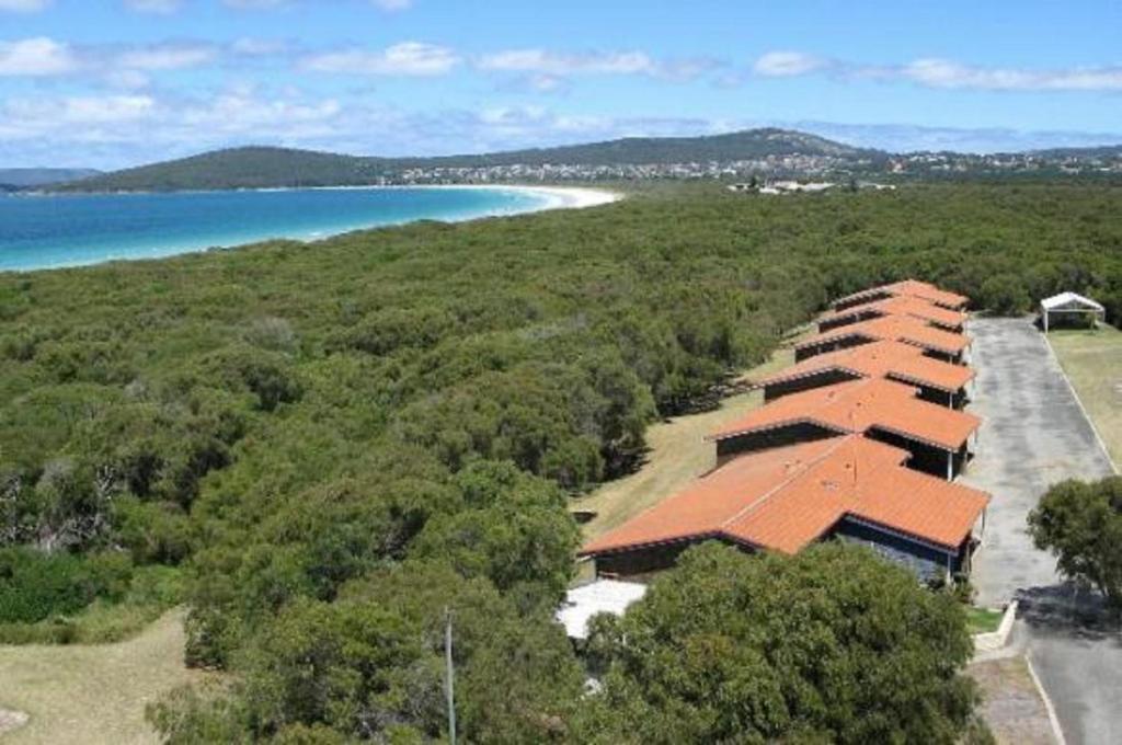 an aerial view of a building next to a beach at Emu Beach Chalets in Albany