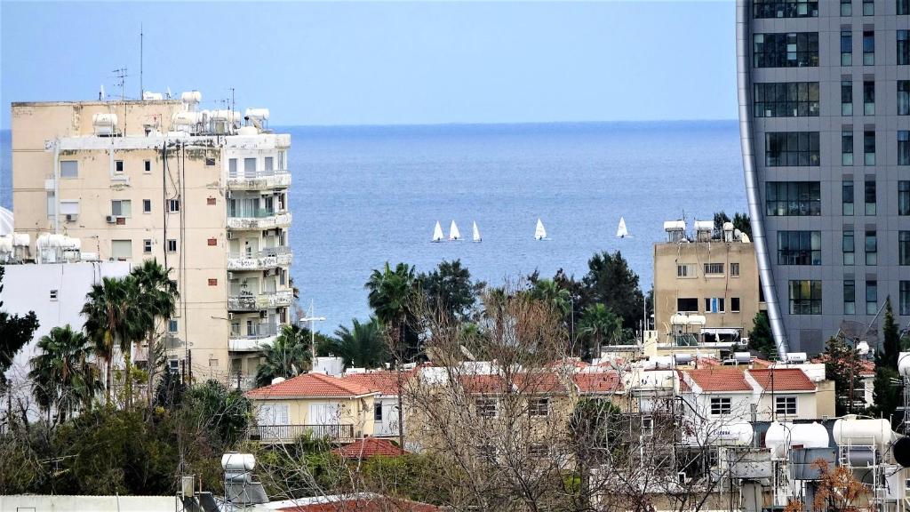 a city with buildings and sailboats in the water at Antonakis 501 in Limassol