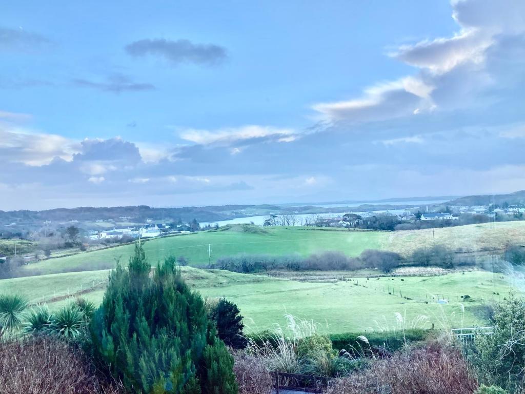 a view of a green field with trees at Private 3 bedroom house ideal for family & friends in Killybegs