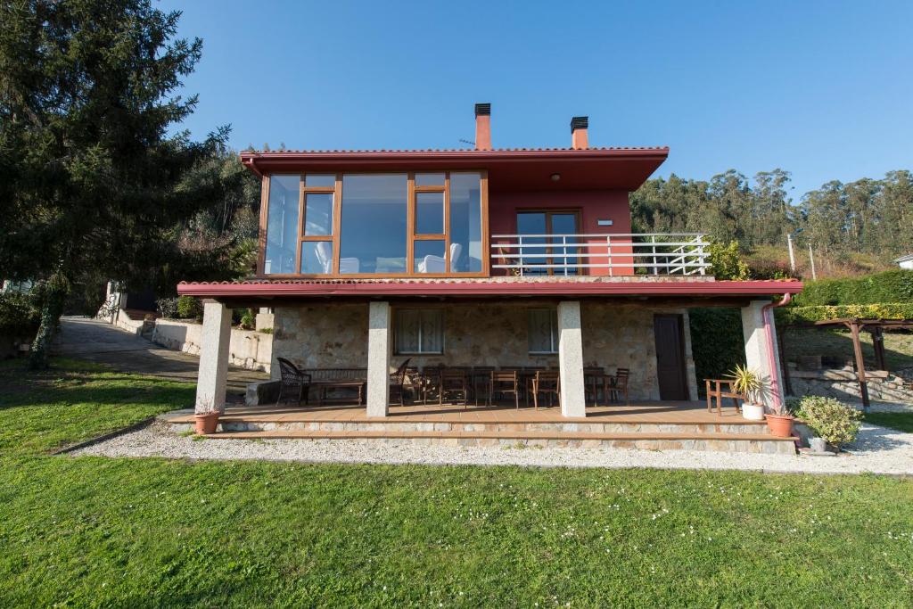 a house with a large deck with a balcony at Casa de Sabela in Culleredo