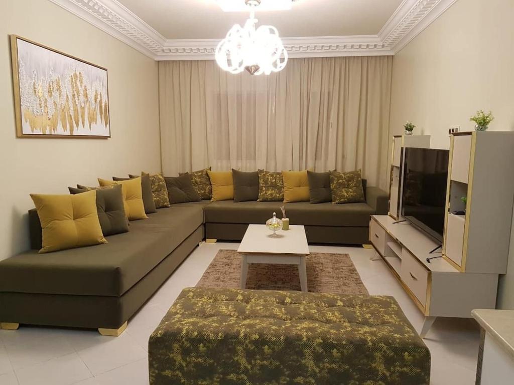a living room with a couch and a tv at New Luxury Apartment, 3 Bed, 7Mins to Beach - Aida in Tangier