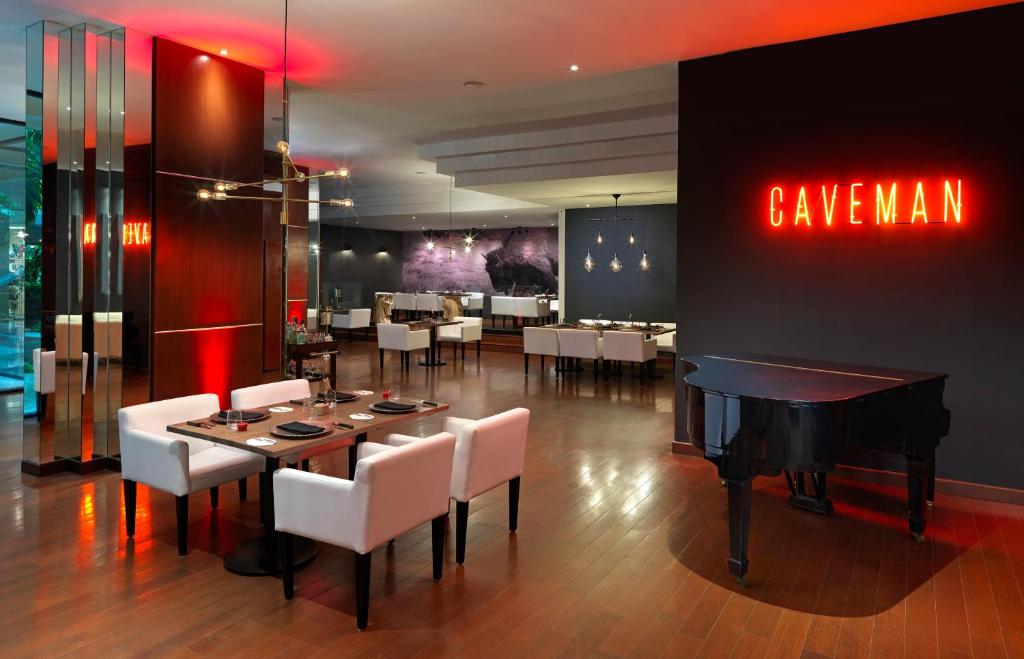 a dining room with a table and a piano at Paradisus Cancun All Inclusive in Cancún