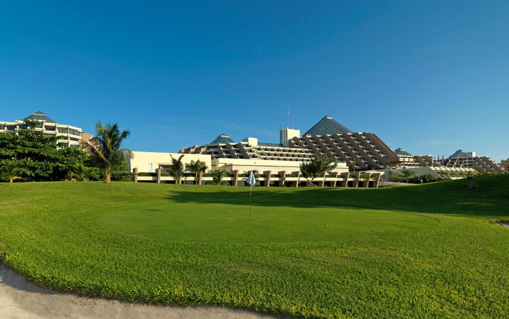 a golf course in front of a resort at Paradisus Cancun All Inclusive in Cancún