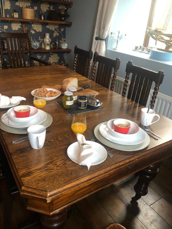 a wooden table with plates of food on it at Stone Lodge B&B in Balrath