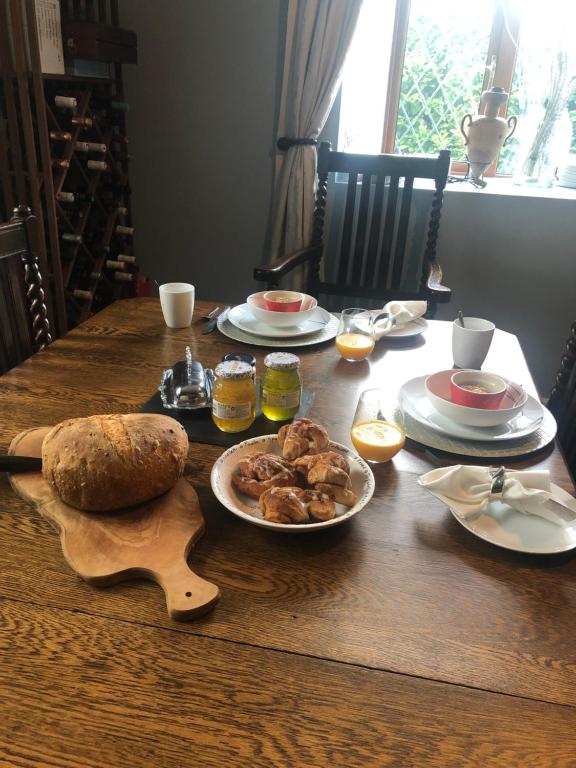 a table with plates of food and bread on it at Stone Lodge B&B in Balrath