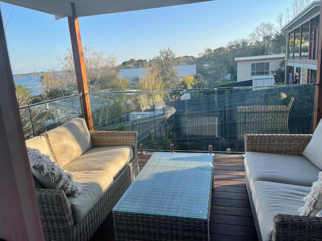 a balcony with couches and a view of the ocean at Seadale in Rhyll