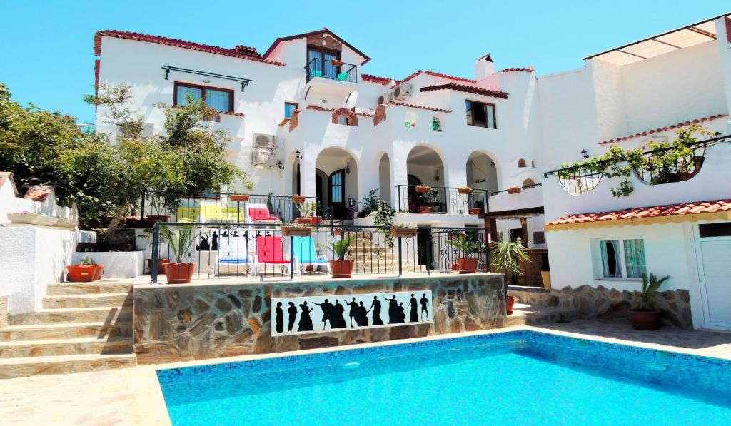 a villa with a swimming pool in front of a house at Villa Dreams in Selcuk