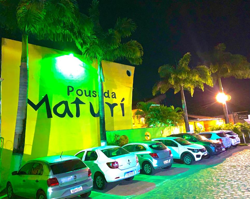 a row of cars parked in front of a parking lot at Pousada Maturi - Pipa in Pipa