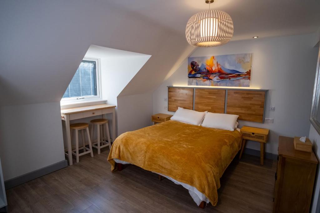 a bedroom with a bed and a desk and a window at Magnolia House, Rye in Rye