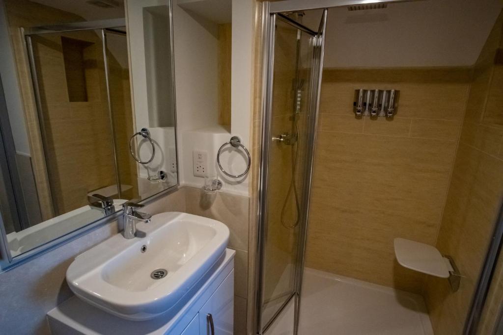 a bathroom with a sink and a shower at Magnolia House, Rye in Rye