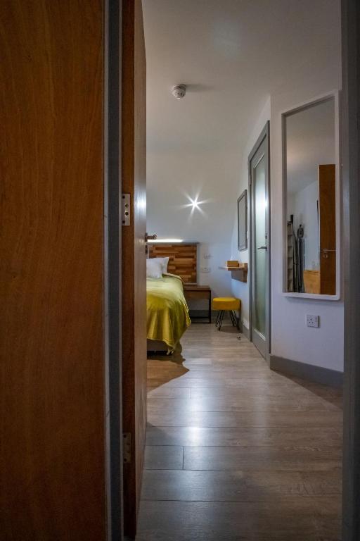 a room with a bed and a room with a hallway at Magnolia House, Rye in Rye
