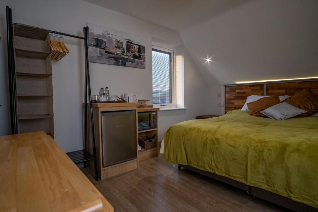 a bedroom with a bed and a table in it at Magnolia House, Rye in Rye