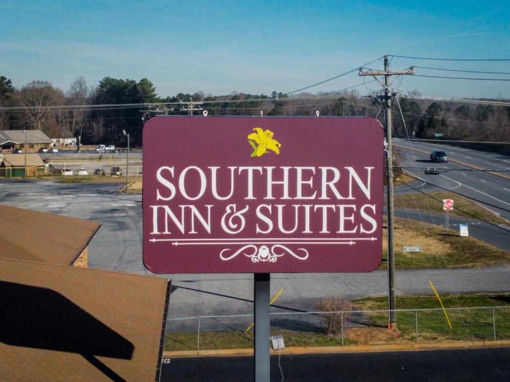 una señal púrpura para una posada y suites del sur en Southern Inn and Suites, en Spartanburg