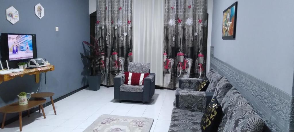 a living room with a room with hockey equipment at CAMELIA HOLIDAY APARTMENT in Kuah