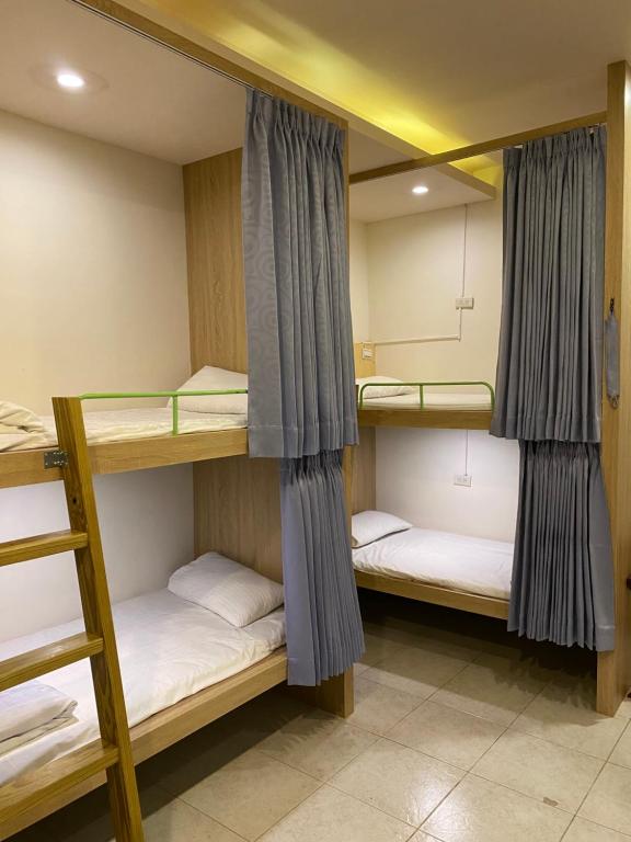 two bunk beds in a dorm room at Kenting Heng-Chung Art Hostel in Hengchun