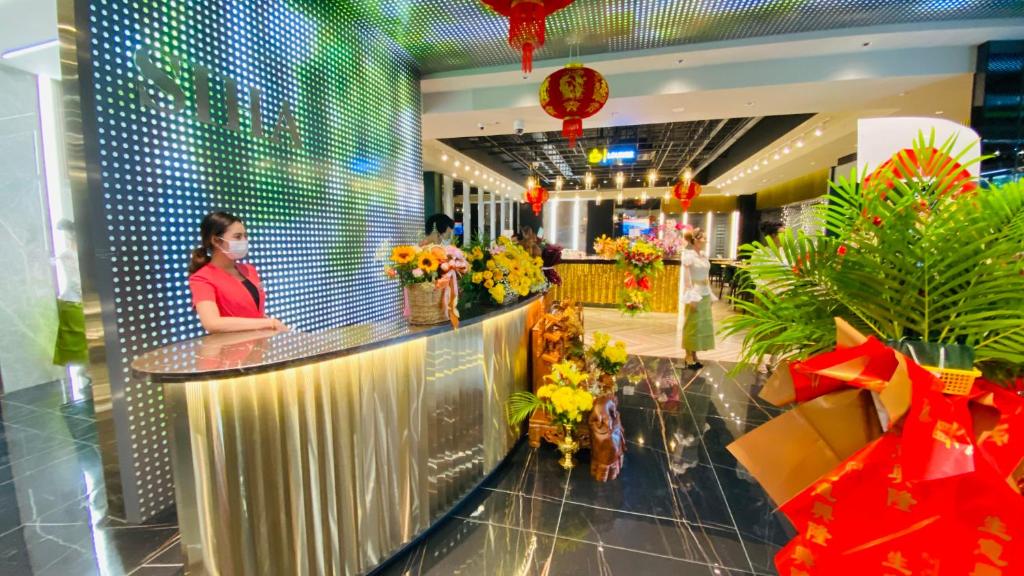 a woman standing at a counter in a shopping mall at Siha Treasure Hotel in Sihanoukville