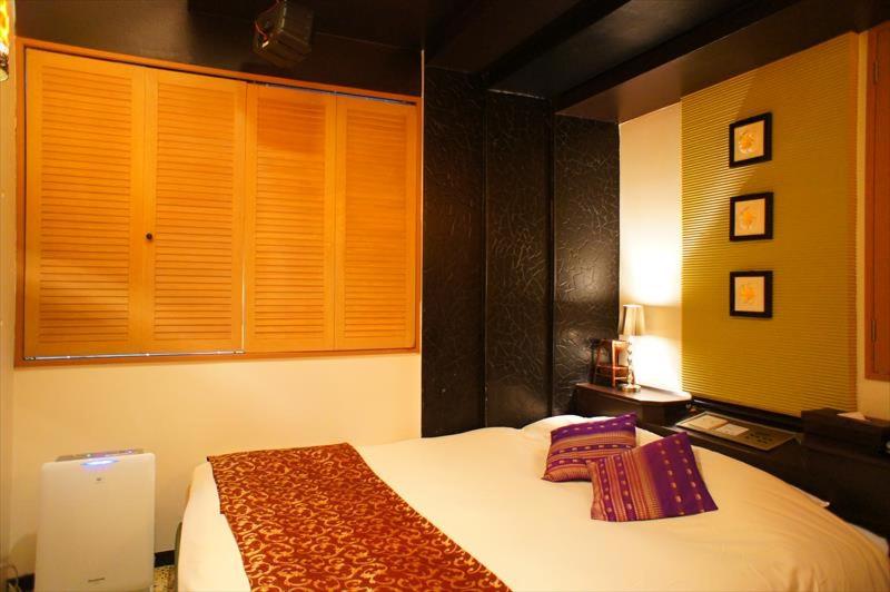 Postel nebo postele na pokoji v ubytování HOTEL CHECK INN BALI adult only