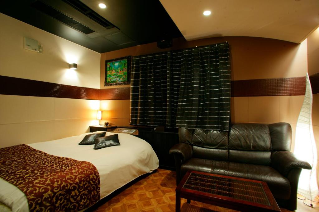 Postel nebo postele na pokoji v ubytování HOTEL CHECK INN BALI adult only