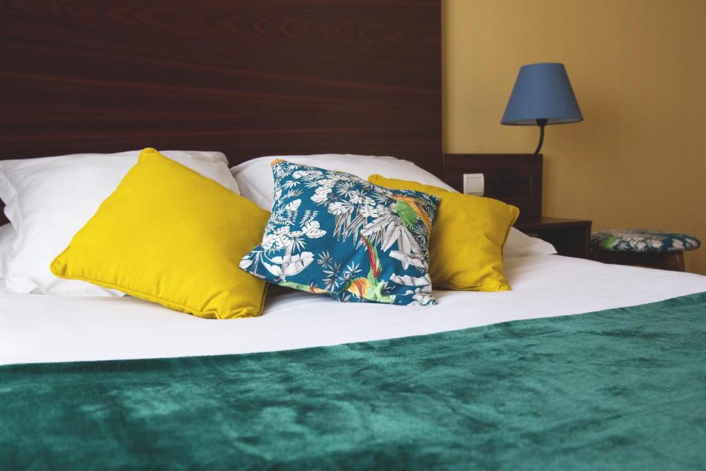 Postel nebo postele na pokoji v ubytování Hôtel Les Coutainvillaises