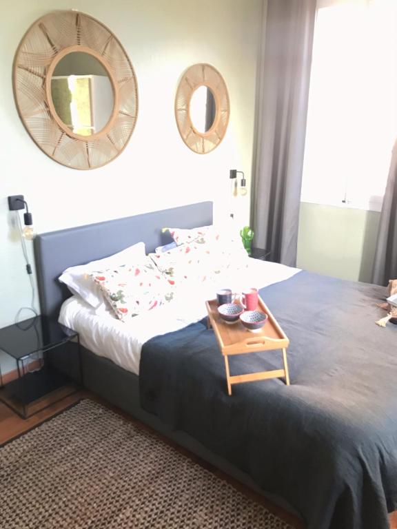 a bedroom with a bed with a table on it at La chambre de Toutou in Bastia