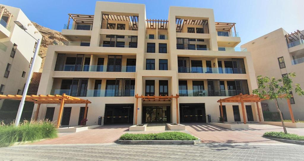 a large white building with a lot of windows at ONE Elegant Apartment in Muscat Bay 01 in Muscat