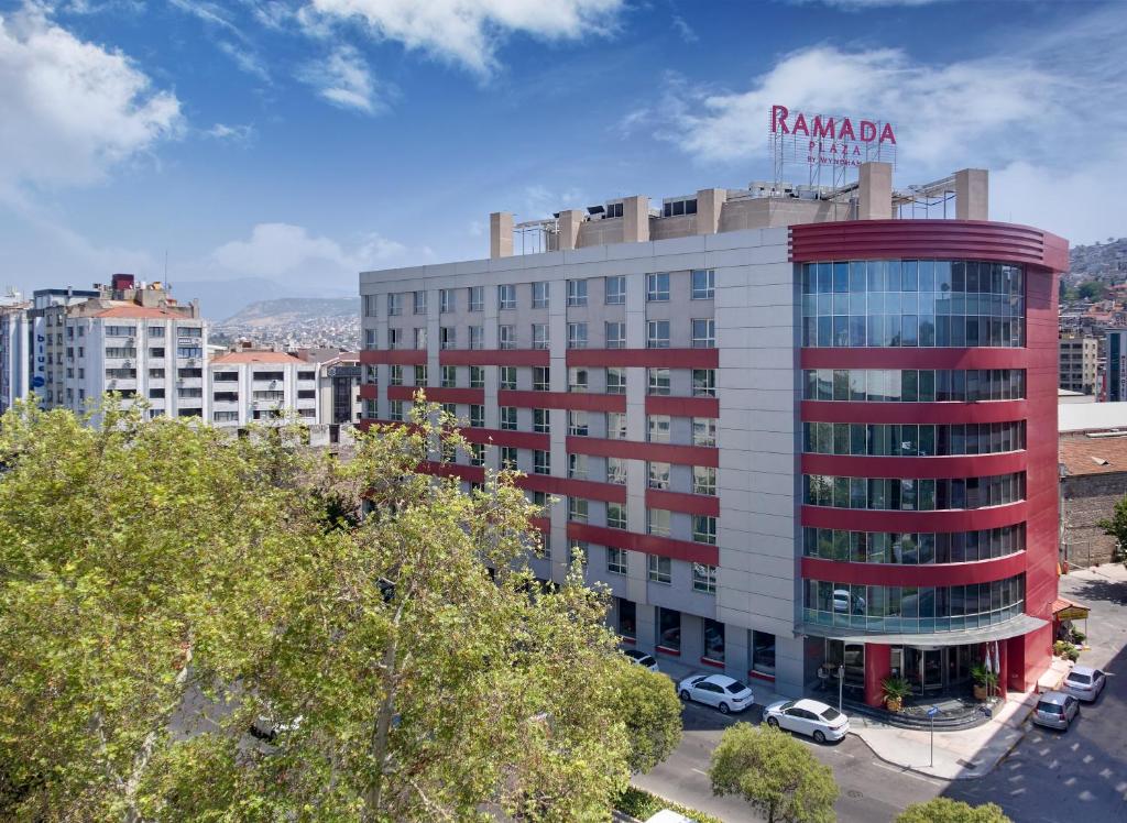 a building with a sign on top of it at Ramada Plaza By Wyndham Izmir in Izmir
