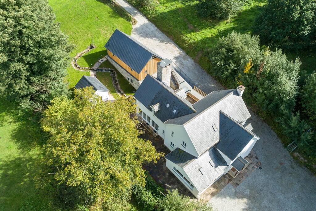 an aerial view of a house with a roof at Priory House; sleeps 6-20 in Goodleigh