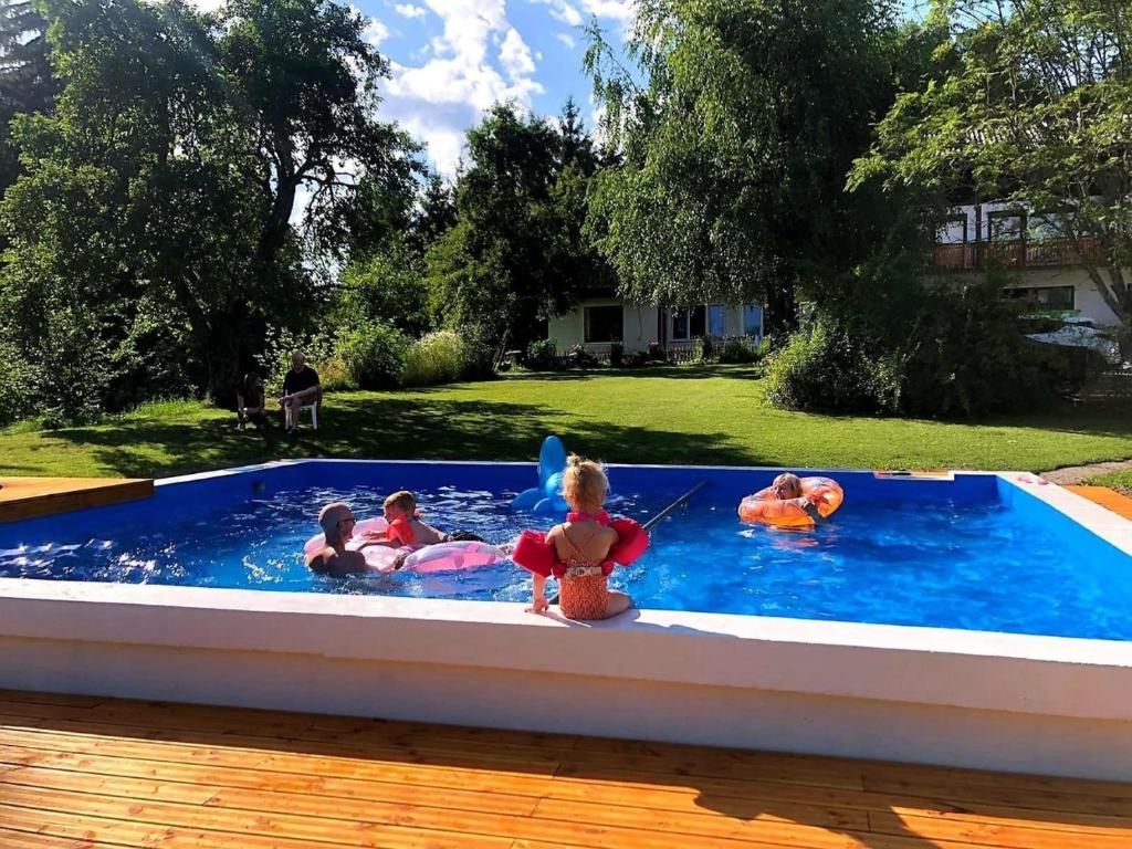 a group of children playing in a swimming pool at Gailtaler Apartments Alinkhof in Bach