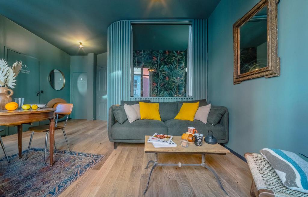 a living room with a couch and a table at Papagayo, appartement halles et côte des basques in Biarritz