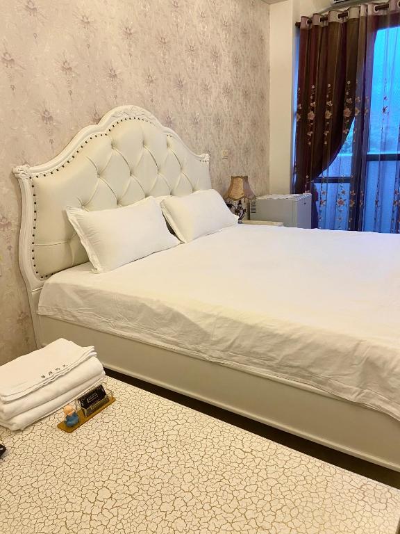a bedroom with a large bed with a white bed frame at 花蓮漫漫時光電梯包棟民宿 in Hualien City