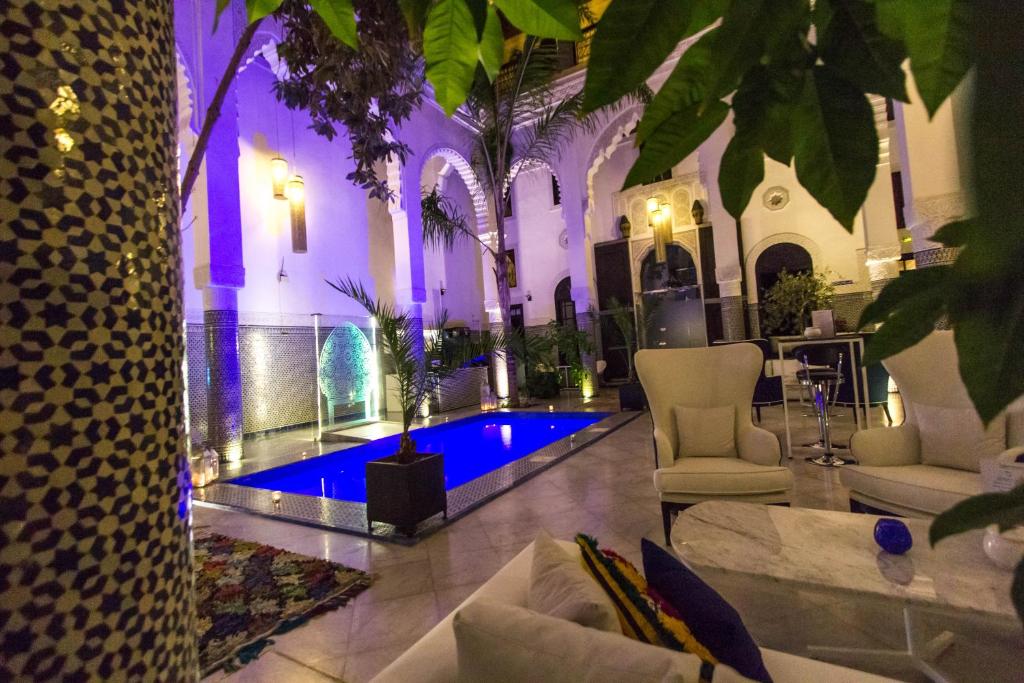 a lobby with a swimming pool in a building at Riad Braya in Fez