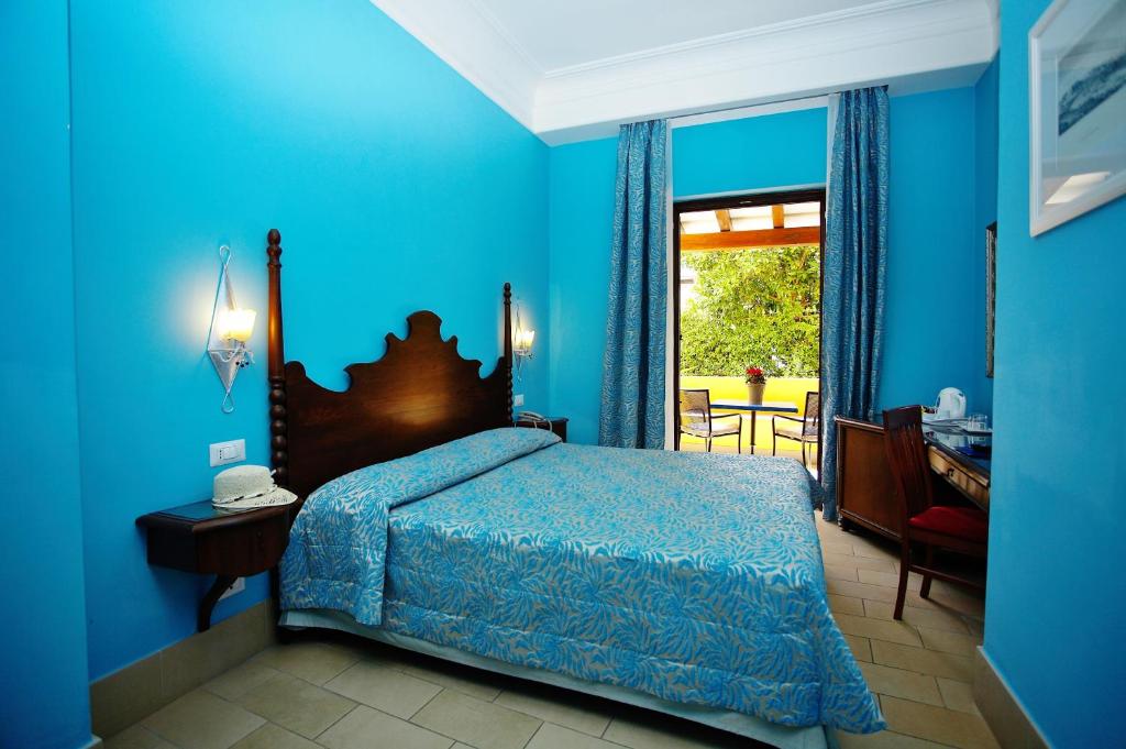 Postel nebo postele na pokoji v ubytování Arciduca Grand Hotel