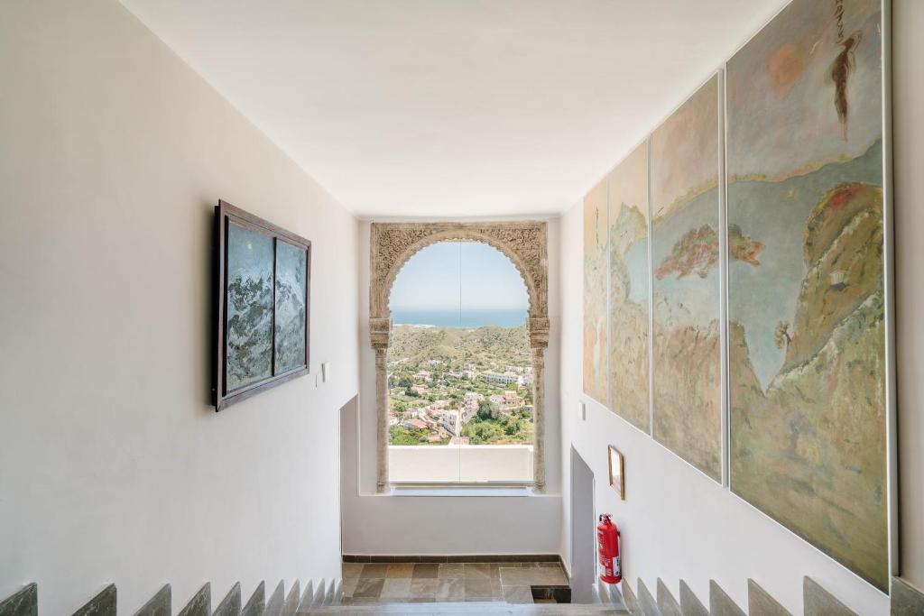 a hallway with a window and a map on the wall at Boutique Hotel Mamabels in Mojácar