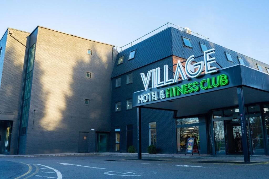 a building with a sign on the side of it at Village Hotel Bracknell in Bracknell