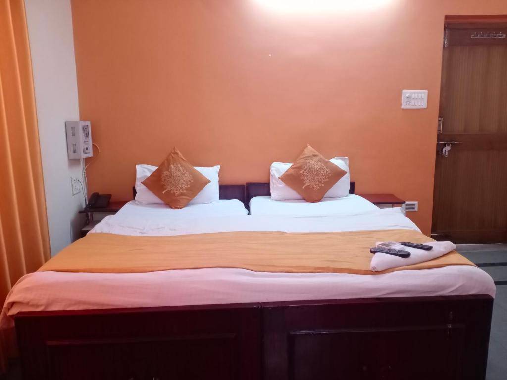 a bedroom with a large bed with two pillows at Mrignayani in Gwalior