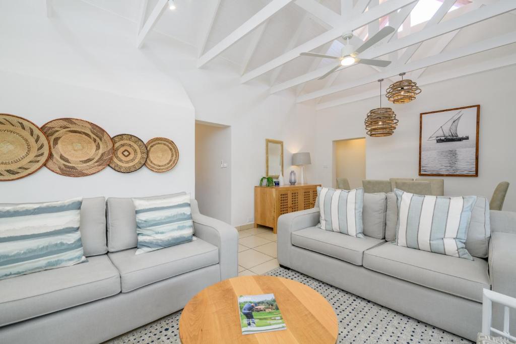 a living room with two couches and a table at San Lameer Villa 2609 - 3 Bedroom Superior - 6 pax - San Lameer Rental Agency in Southbroom