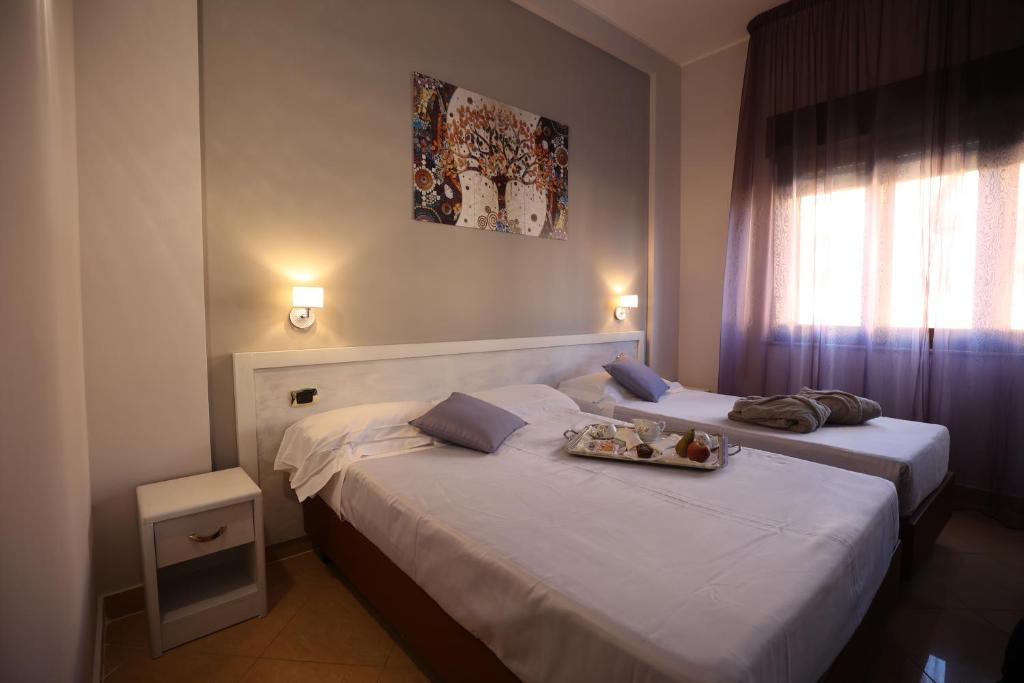 Postel nebo postele na pokoji v ubytování Grand Hotel Paradiso