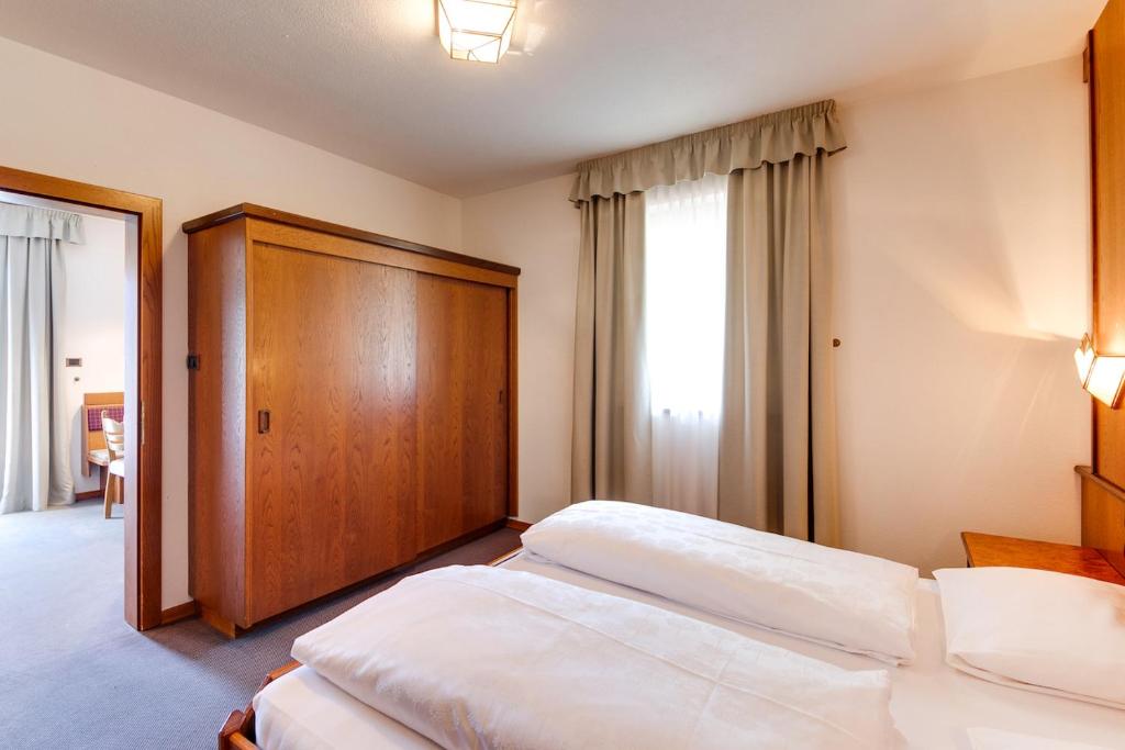 Postel nebo postele na pokoji v ubytování Smy Koflerhof Wellness & Spa Dolomiti
