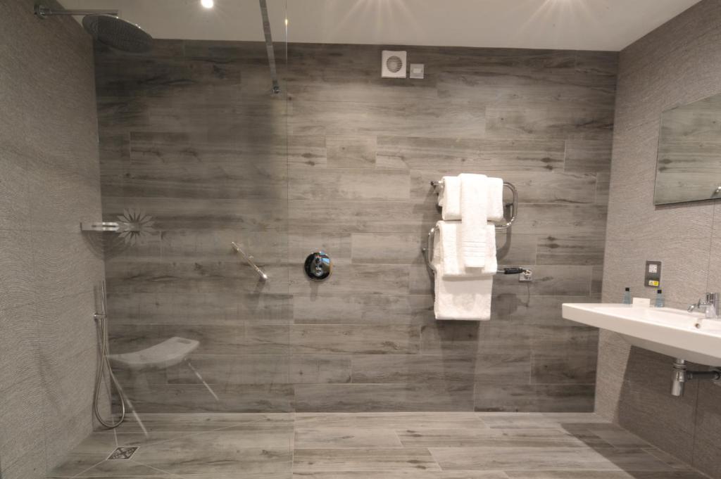 a bathroom with a shower and a sink at The Inn on Loch Lomond in Luss