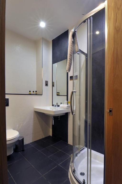 a bathroom with a shower and a sink and a toilet at The Inn on Loch Lomond in Luss