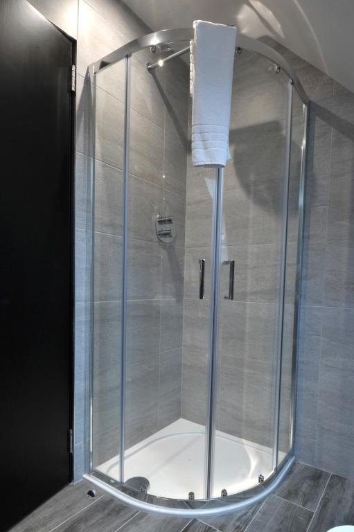 a shower with a glass enclosure in a bathroom at The Inn on Loch Lomond in Luss