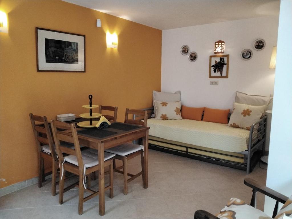 a dining room with a table and a bed at Manta Rota Beach, apartment in a villa, terrace,garden in Manta Rota