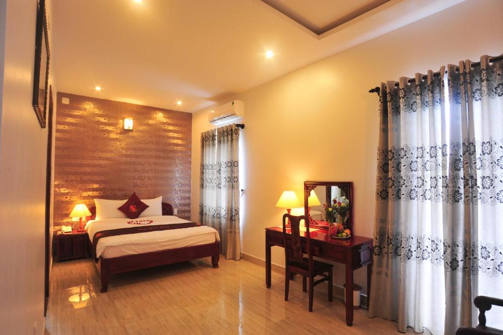 Postel nebo postele na pokoji v ubytování Hong Thien Ruby Hotel