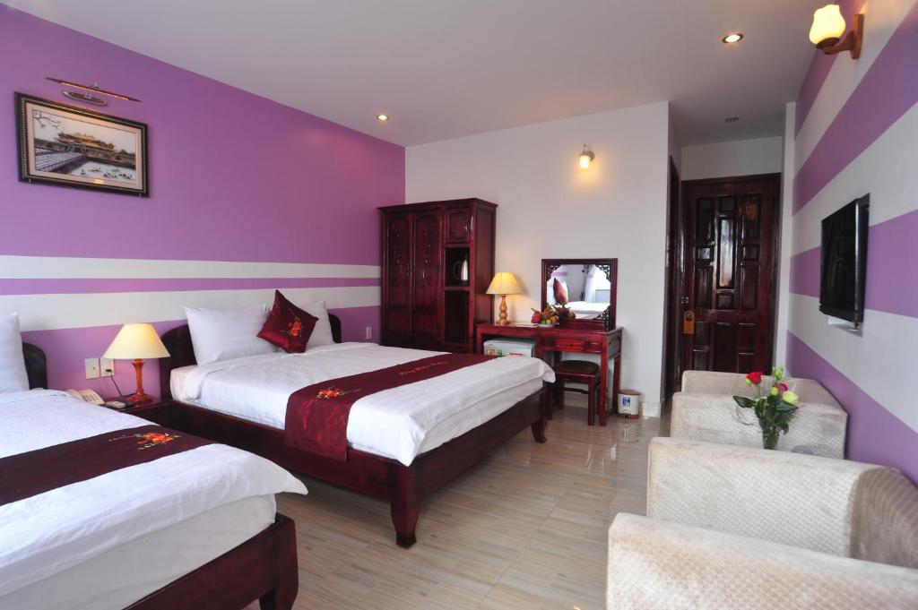 Postel nebo postele na pokoji v ubytování Hong Thien Ruby Hotel