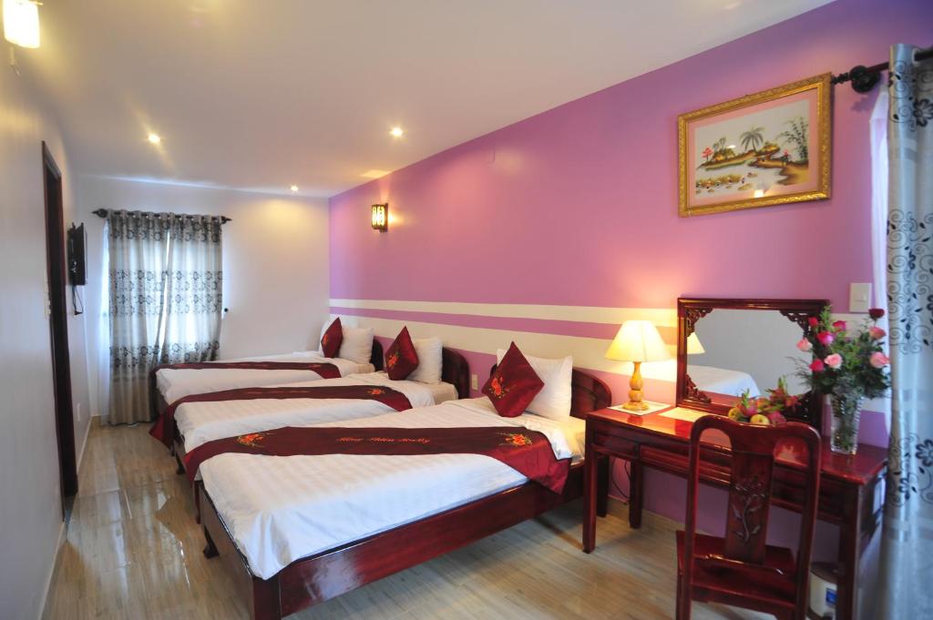 Postel nebo postele na pokoji v ubytování Hong Thien Ruby Hotel