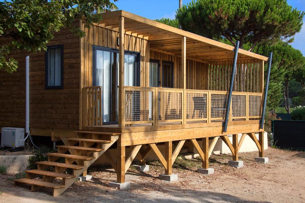 a house being constructed with a porch and stairs at Camping la Croix du Sud in Saint-Tropez